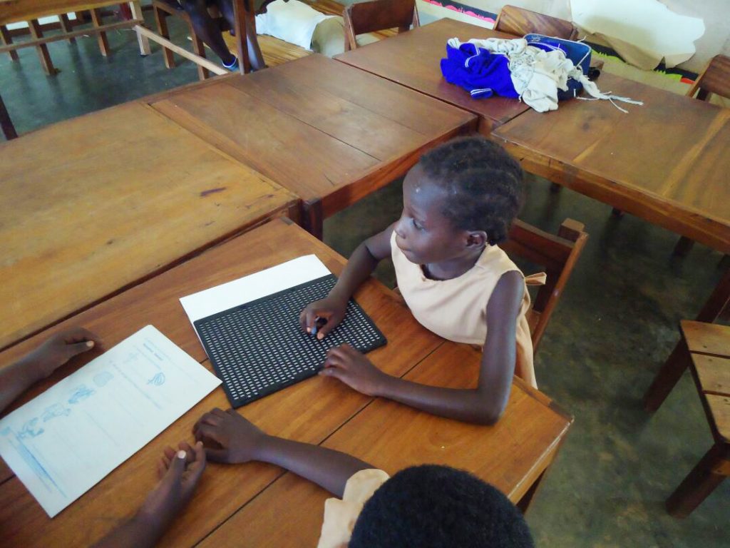 A student learns braille in one of the Cheshire schools.