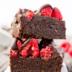 These healthy Raspberry and Chocolate Protein Brownies are deliciously moist and extra rich. Naturally sweetened, this melt in your mouth protein snack is the perfect post-workout treat. Made with dates and almond flour, this guilt-free, decadent dessert is also paleo, vegan, gluten-free, dairy-free, egg-free and flourless.