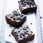 These rich and fudgy black bean protein brownies are the perfect post-workout treat! This super healthy snack is entirely flourless, gluten-free, vegan, dairy-free, egg-free, refined sugar-free and nut-free. Naturally sweetened with maple syrup and filled with antioxidants, these delicious brownie protein bars only require a few minutes of your time and a good food processor. | www.onecleverchef.com