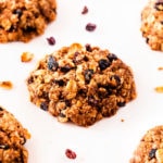Several oatmeal raisin cookies placed on a white background.