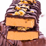 4 chocolate peanut butter protein bars stacked.