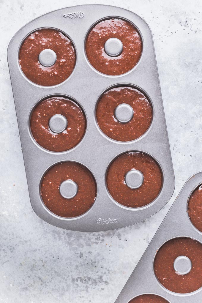Chocolate protein donut dough in two donut pans