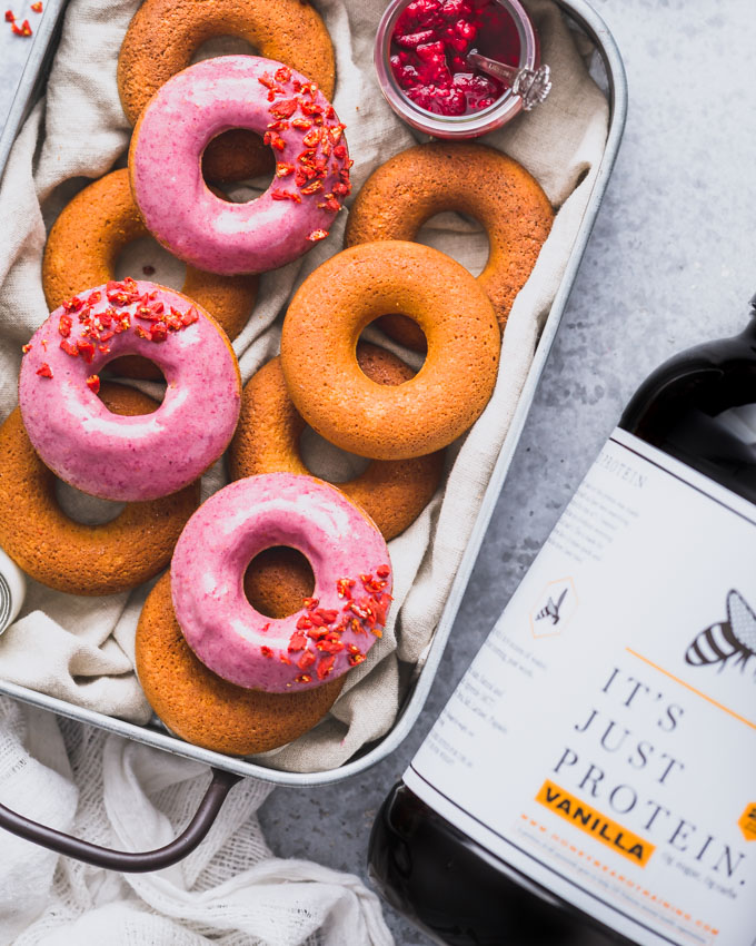 Vanilla Protein Donuts in a metal tray and a whey protein tub