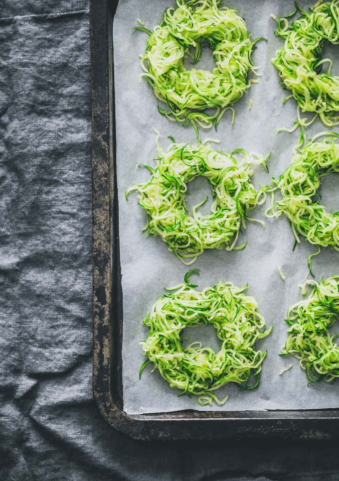 Zucchini egg nests on a sheet pan without the eggs