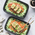 Two Vegan Peanut Butter Tofu on Zoodles servings in meal prep containers