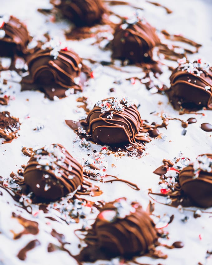 Candy Cane Protein Truffles, coated and decorated, on parchment paper