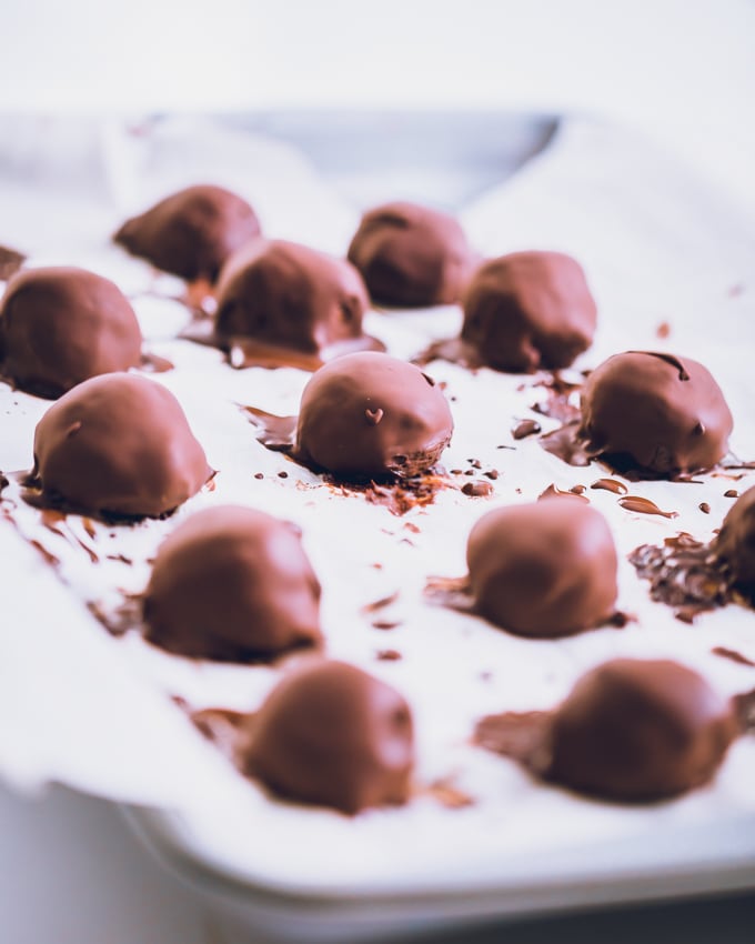 Candy Cane Protein Truffles, coated, on parchment paper