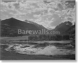Lake and trees in foreground, mountains and...
