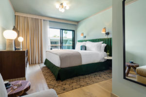 Palihotel Hollywood - wide shot of room with full length mirror, decorative, small table, credenza, bit, Lampson TV, bed area