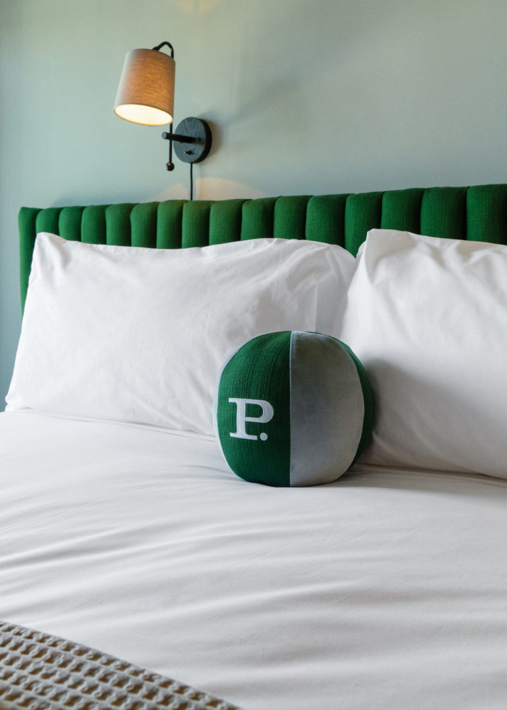 Palihotel Hollywood - class that bad head shot with round pillow and lamp above padded headboard