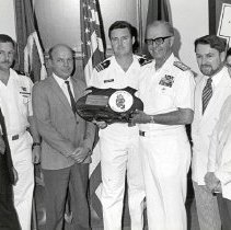 Draper Kauffman receiving a UDT plaque with Joseph "Bud" A Bechtold, Jr.