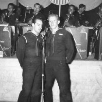 Pair of sailors sing at 10th st USO