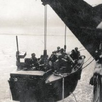 Boat crew & UDT11 swimmers being lowered from ship