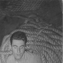 sailor sleeping in a pile of rope