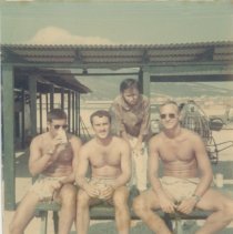 four sailors near a shelter