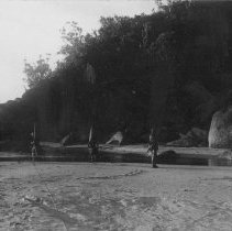 sailors on beach at water's edge