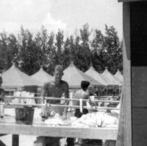 3 sailors near tents