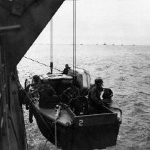 Sailors in LCPR being lowered from APD, March 27, 1946 Okinawa