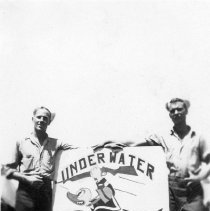 two sailors with UDT Team 10 sign