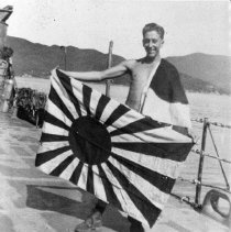 UDT member hold Japanese battle flag