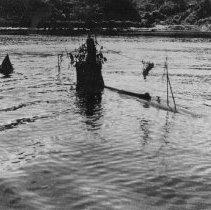 Japanese midget submarine waits demolition.