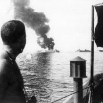 #13 Leyte Gulf Nov 1944 NCDU OIC LT JG Robert Eiring looks on from the deck
