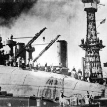Burning holes in side of U.S.S. Oklahoma to remove men trapped below.
