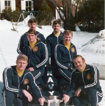 Navy Bobsled Team with sled and holding a trophy