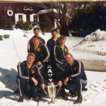 Navy Bobsled Team with sled and holding a trophy