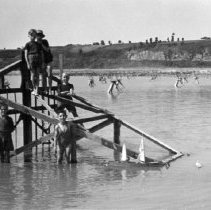Children in France climbing on a beach obstacle