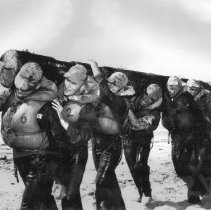 Trainees carrying log