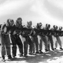 Trainees holding log