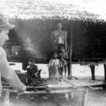 OSS Maritime Unit member with native hut in background