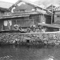 Japanese Workers On A Jetty