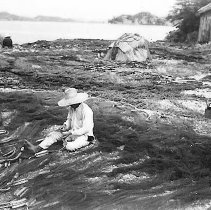 Man Repairing Fishing Nets