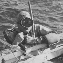 returning to he boat Mr. Rebikoff re-cools the motor inside of his diver's