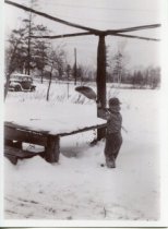Wayne Barth clears off the snow on a rotary clothesline