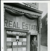 Real Estate office with Ed. Johnson in doorway.  Bldg remodeled 1929