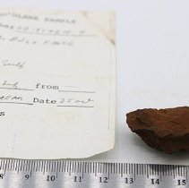 Adze flake with artifact slip and ruler