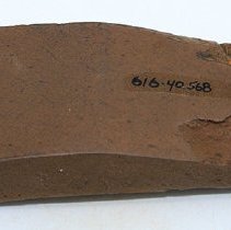 Polished side of basalt adze fragment