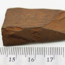 Basalt adze fragment with ruler