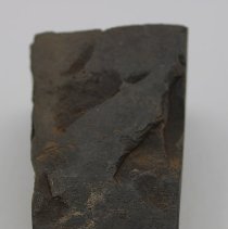 Lengthwise view of basalt adze fragment