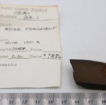 Adze fragment with artifact slip and ruler