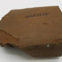 Basalt adze fragment with alternate id number  visible