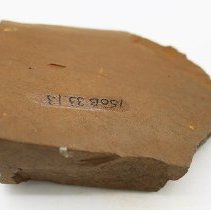 Basalt adze fragment with alternate id number visible