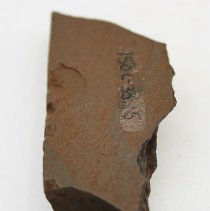 Side of basalt adze fragment with alternate id number visible