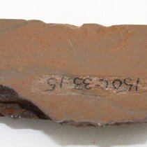Basalt adze fragment with alternate id number visible