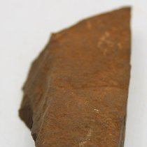 Lengthwise view of a basalt adze fragment