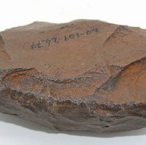 Closeup of basalt adze blank with alternate id number visible