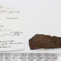 Basalt awl with artifact slip and ruler